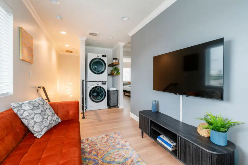 Living room with the stacked washer and dryer beyond