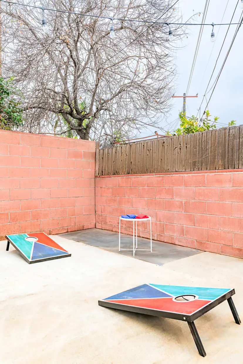 Patio cornhole boards against a block wall