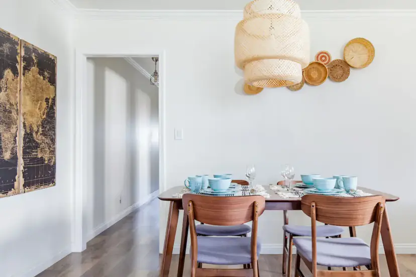 Dining area with a map triptych and rattan pendant