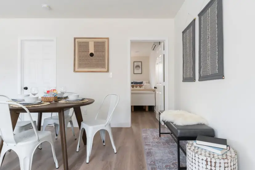 Round dining table with white metal chairs