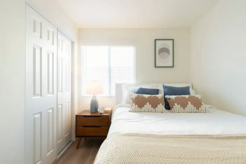 Bedroom with a queen bed and a wood nightstand