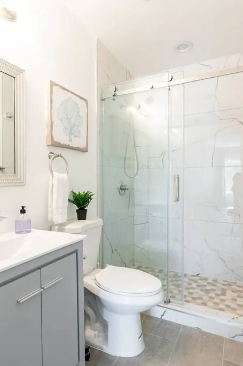 Bathroom with a glass shower and a grey vanity