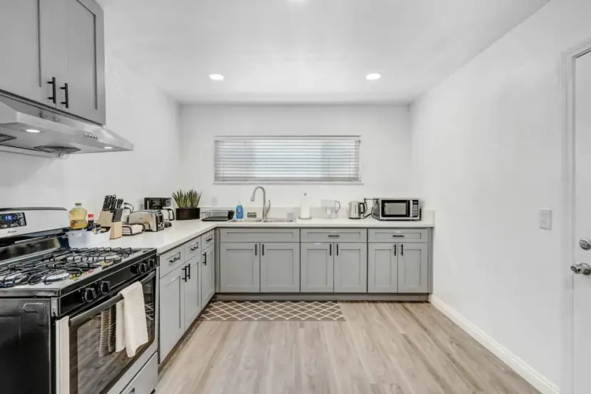 Grey shaker kitchen with a gas range