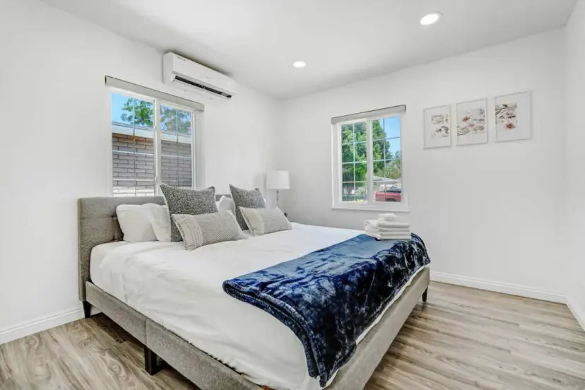 Bedroom with a king bed and a navy throw