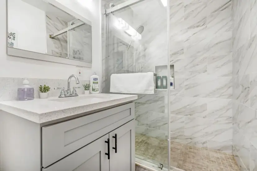 Bathroom with a marble-look glass shower