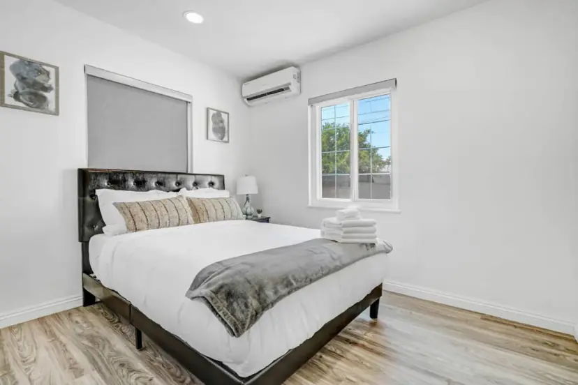 Bedroom with a full bed and a dark headboard