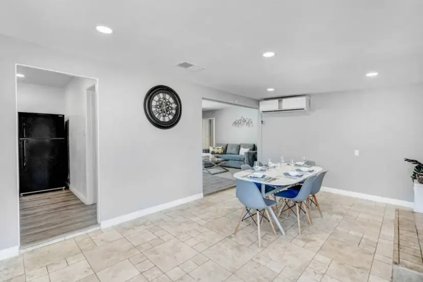 Dining area with a round table and the kitchen beyond