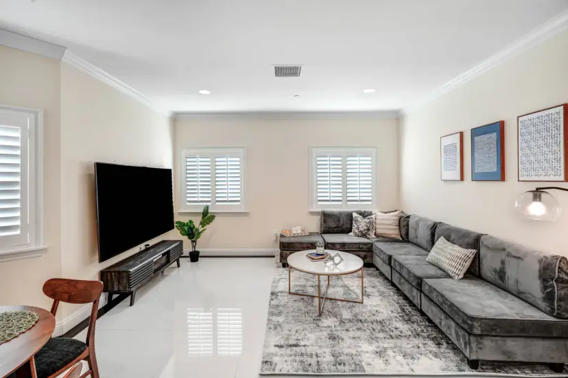 Living room with a large grey sectional and a wall-mounted TV