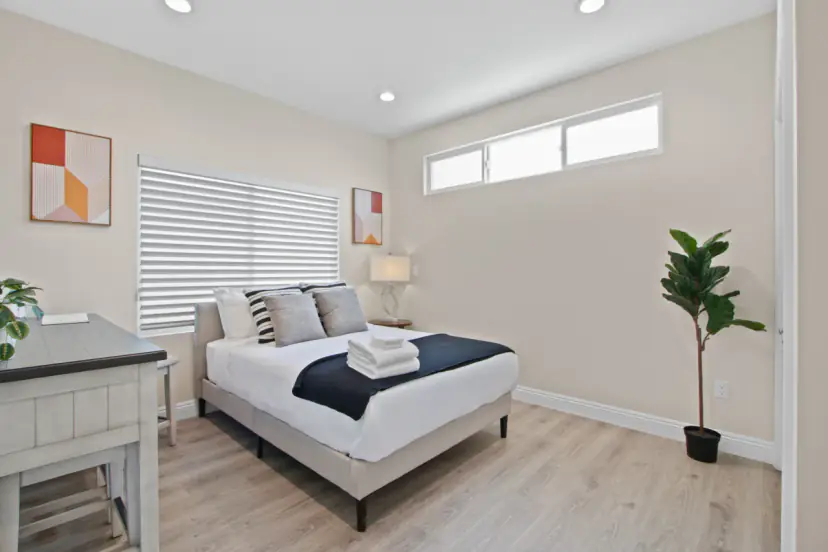 Bedroom with a full bed and a fiddle-leaf fig