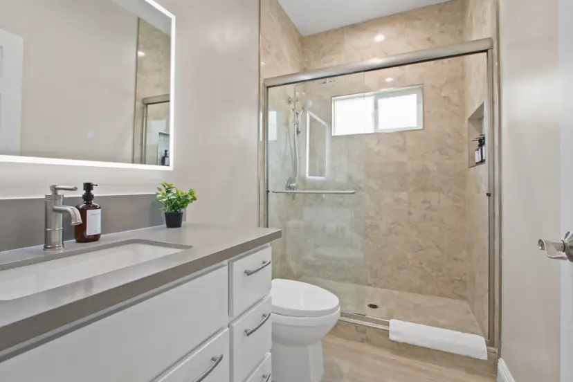 Bathroom with a glass shower and a grey vanity