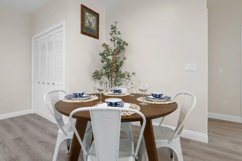 Round dining table with white bistro chairs