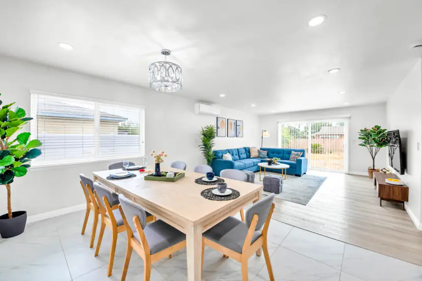 Open dining and living room with a blue sectional
