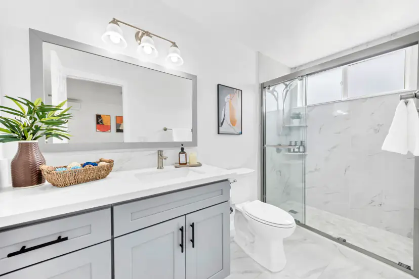 Bathroom with a long vanity and a glass walk-in shower