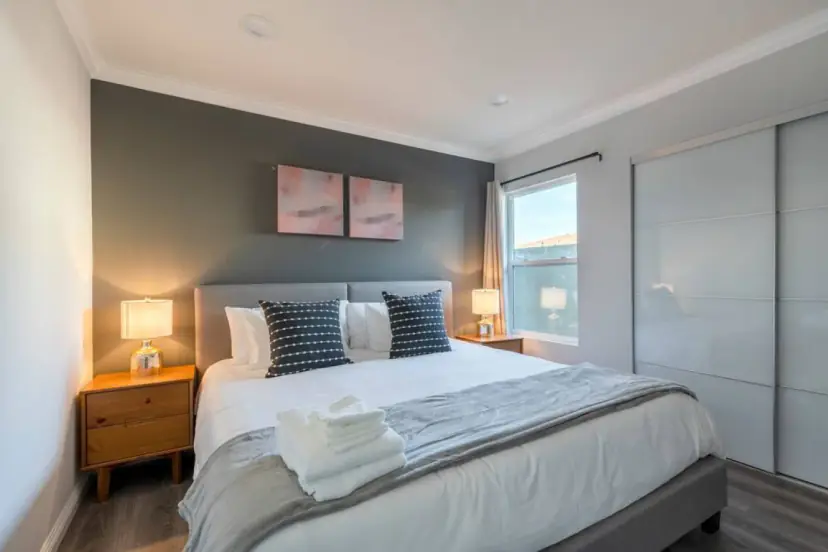 Bedroom with a king bed and a charcoal accent wall