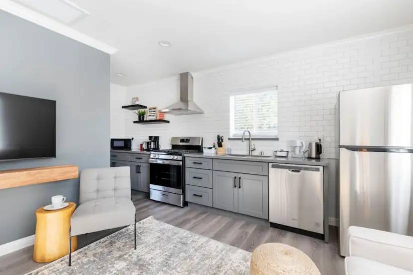 Grey shaker kitchen with a stainless fridge