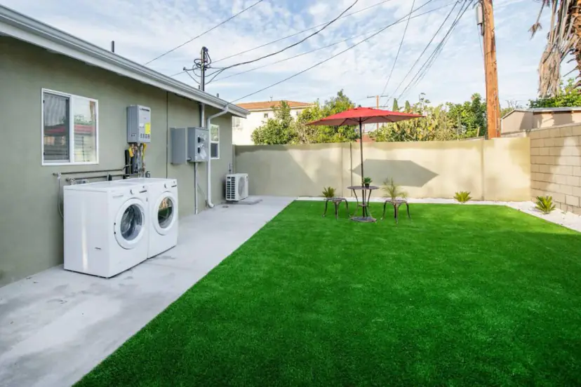 Lawn with an umbrella table and outdoor laundry
