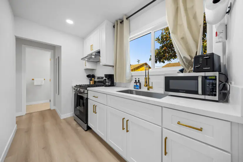 White galley kitchen with a gas range