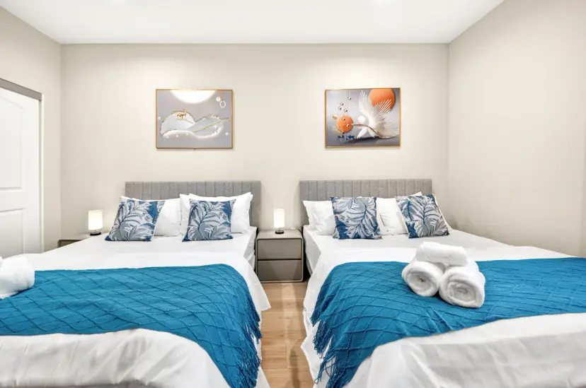 Two beds with teal throws