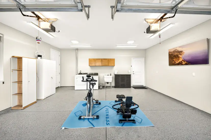 Garage with an exercise bike, rowing machine, washer and dryer