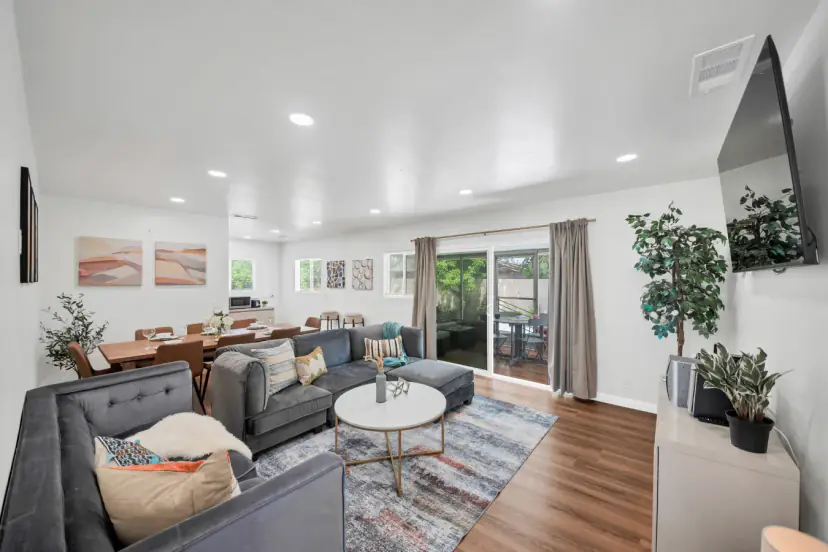 Living room with a grey sectional and sliding doors to the patio