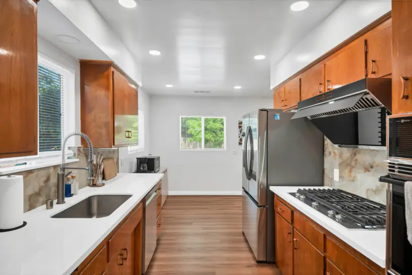 Kitchen with honey-oak cabinets and a gas cooktop