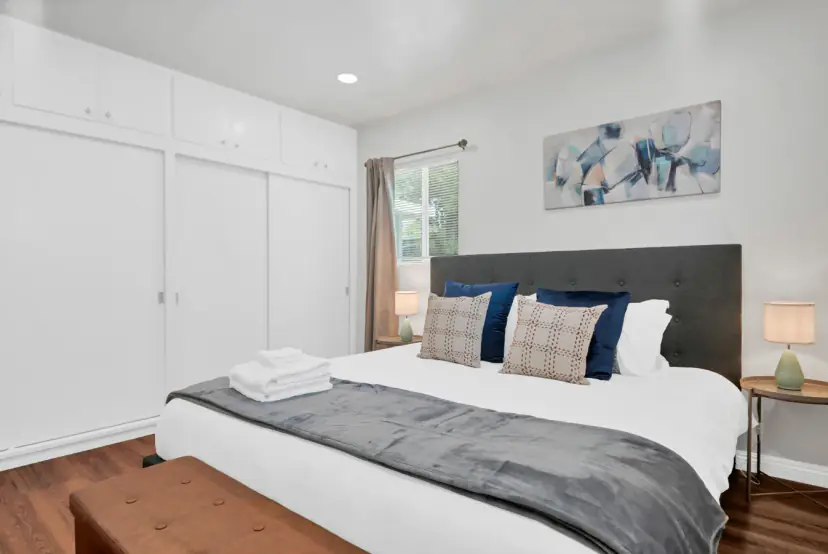 Bedroom with a king bed and a closet wall