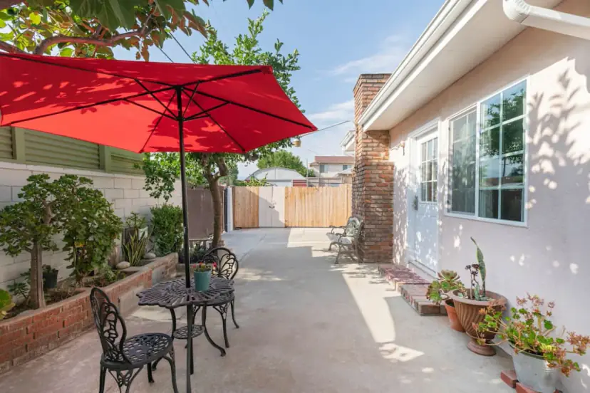 Courtyard with a red umbrella and a bistro set