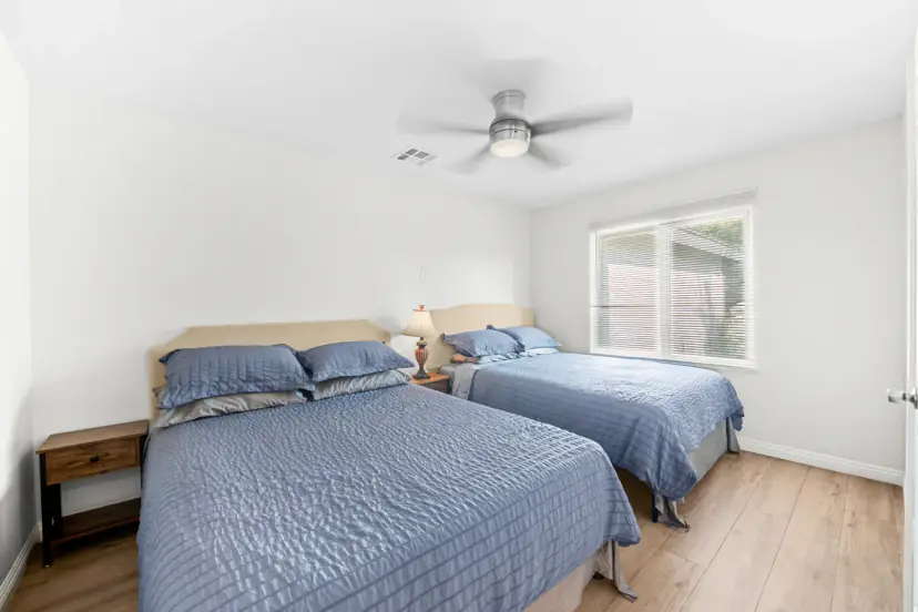 Bedroom with two beds and blue bedspreads