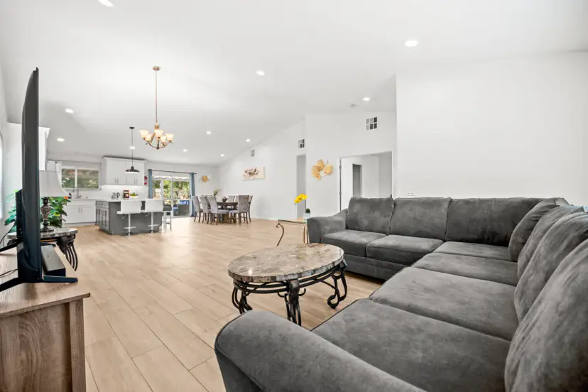 Great room with a sectional and the kitchen beyond