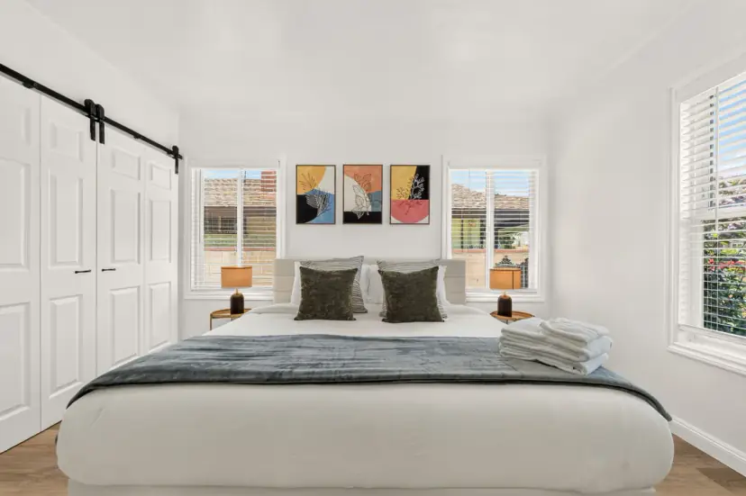 Bedroom with a king bed and colourful framed prints