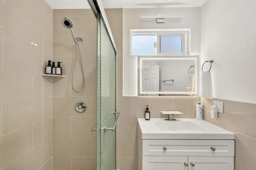 Bathroom with a glass shower and a white vanity