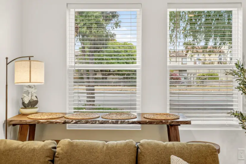 Window bar table with woven place mats behind the sofa