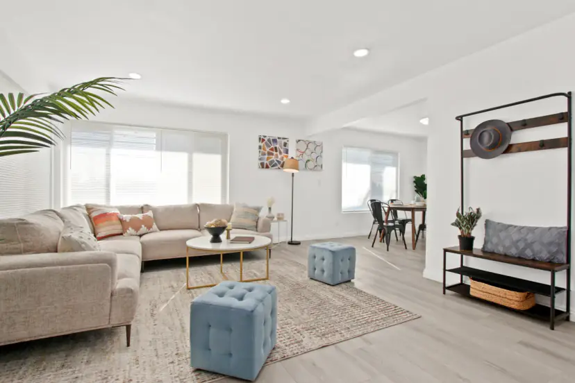 Beige sectional with blue ottomans
