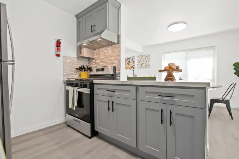 Kitchen peninsula with a gas range and the dining area beyond