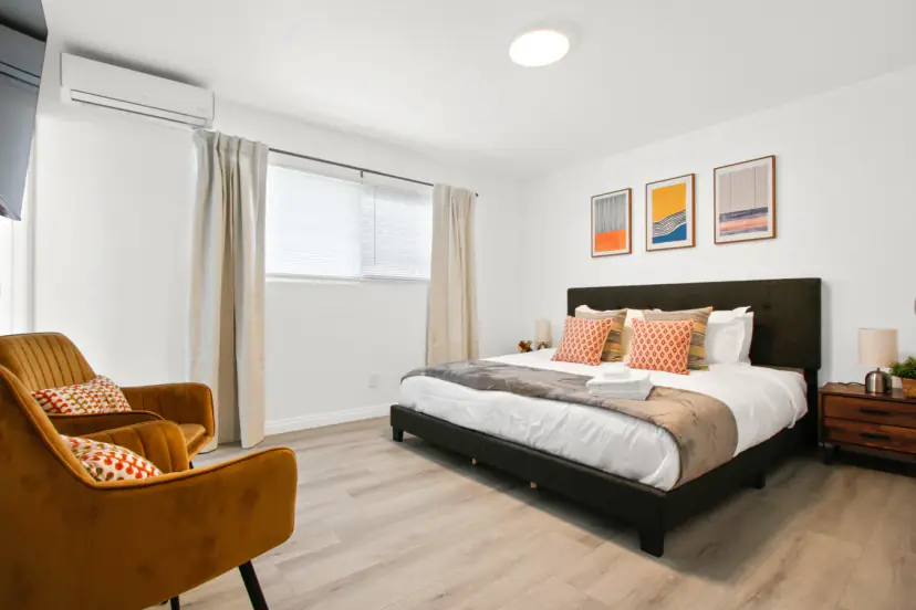 King bed with a mustard velvet armchair