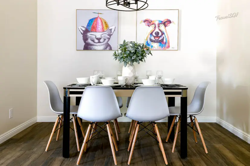 Dining table set for six under playful animal portraits