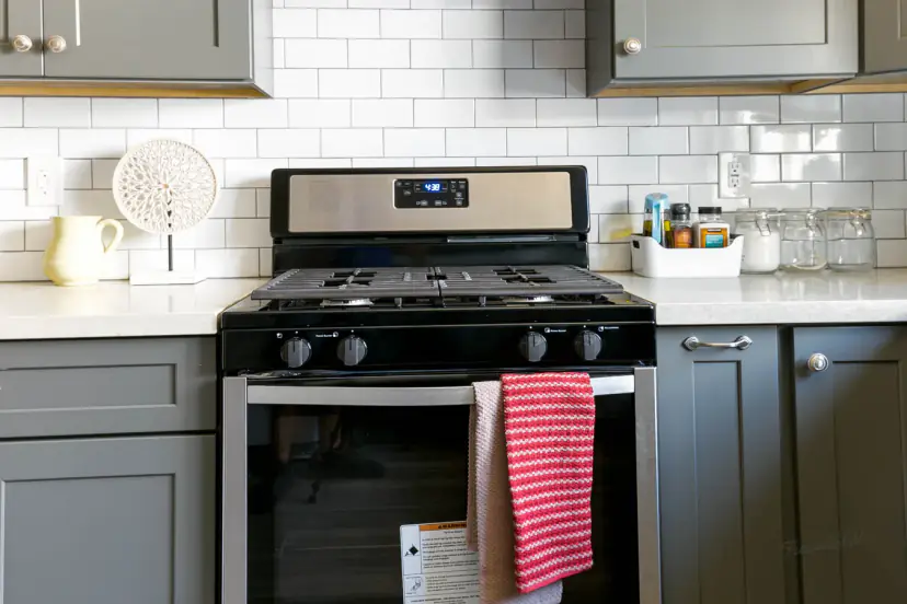 Gas range on white subway tile