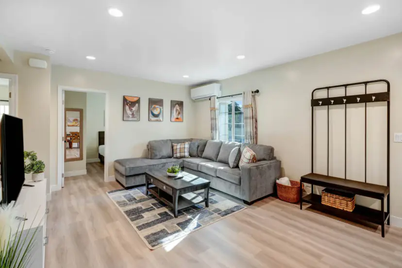 Living room with a grey sectional and a hall tree
