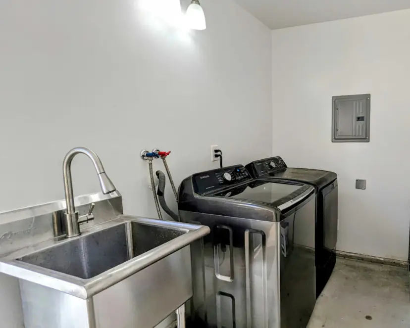 Laundry room with a washer, dryer and utility sink