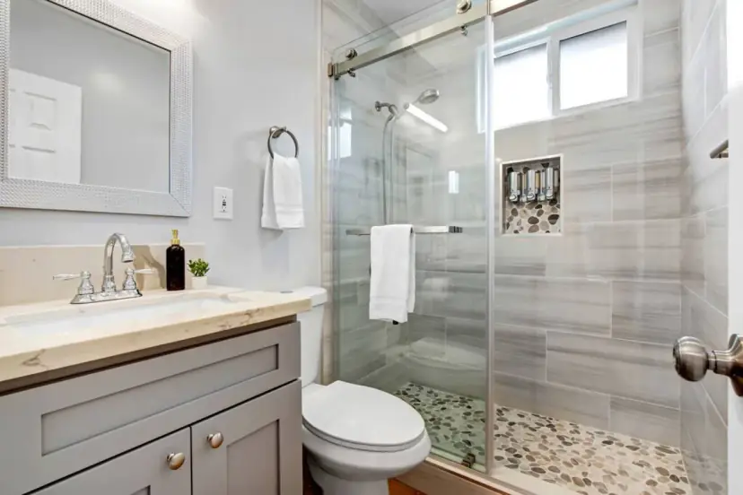 Bathroom with a glass shower and a pebble floor