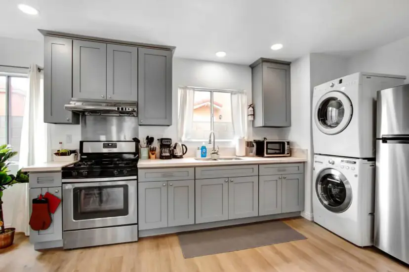 Kitchen with grey cabinets and a stainless fridge
