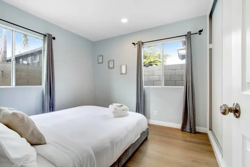 Bedroom with a queen bed and two windows