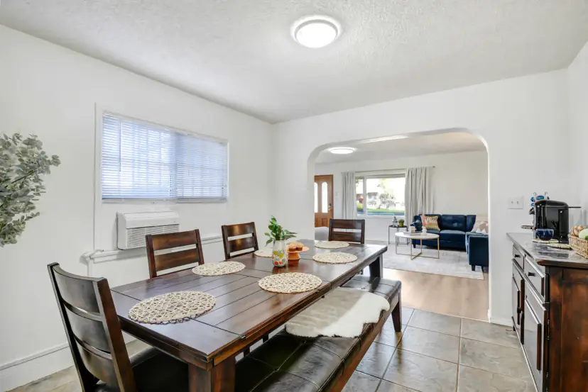 Dining table and bench with an arch to the living room