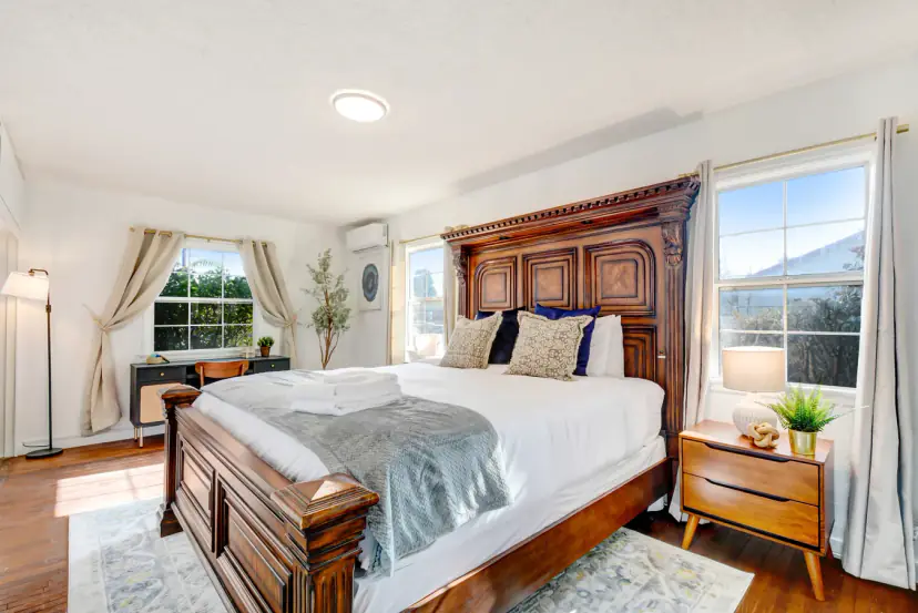 Main bedroom with a carved wood king bed and a desk