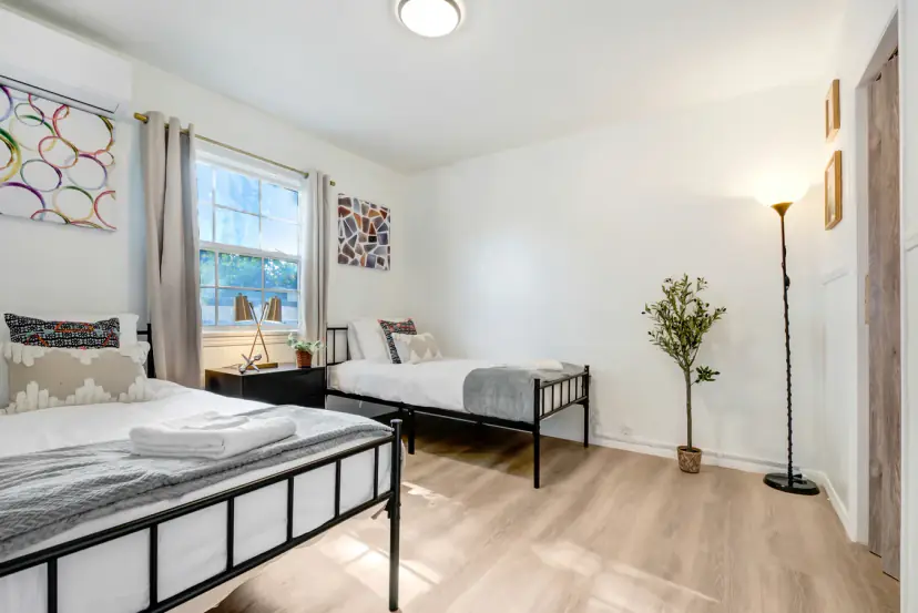 Bedroom with two twin beds and a floor lamp
