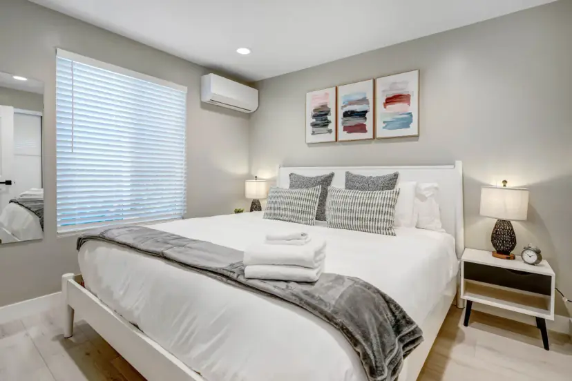 Bedroom with a king bed and a set of framed prints
