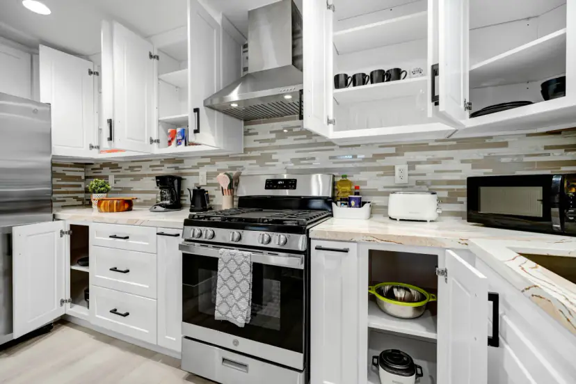 Kitchen with open cabinets and a microwave