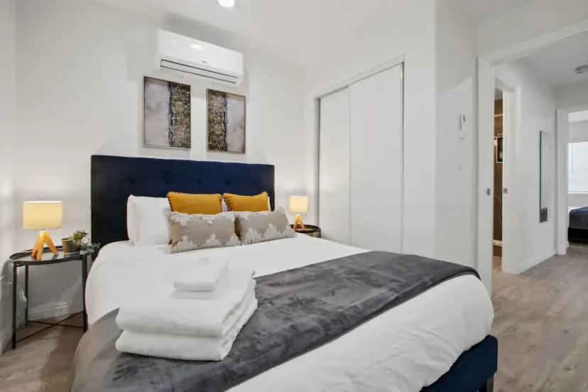 Bedroom with a navy headboard and mustard pillows