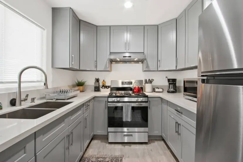 Kitchen with a stainless fridge and a range hood