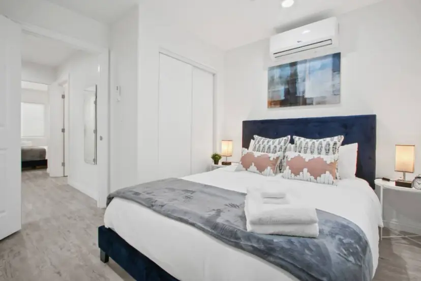 Bedroom with a navy headboard and patterned pillows